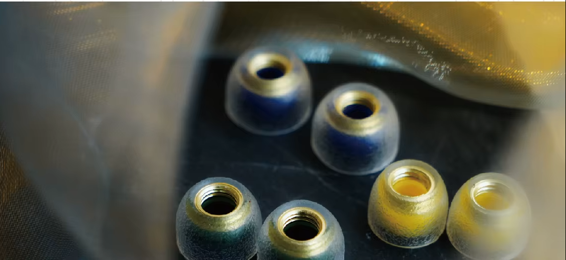 3 pairs of tangzu sancai tips with metallic gold and blue gradient accents, arranged on a dark surface with a blurred metallic background.