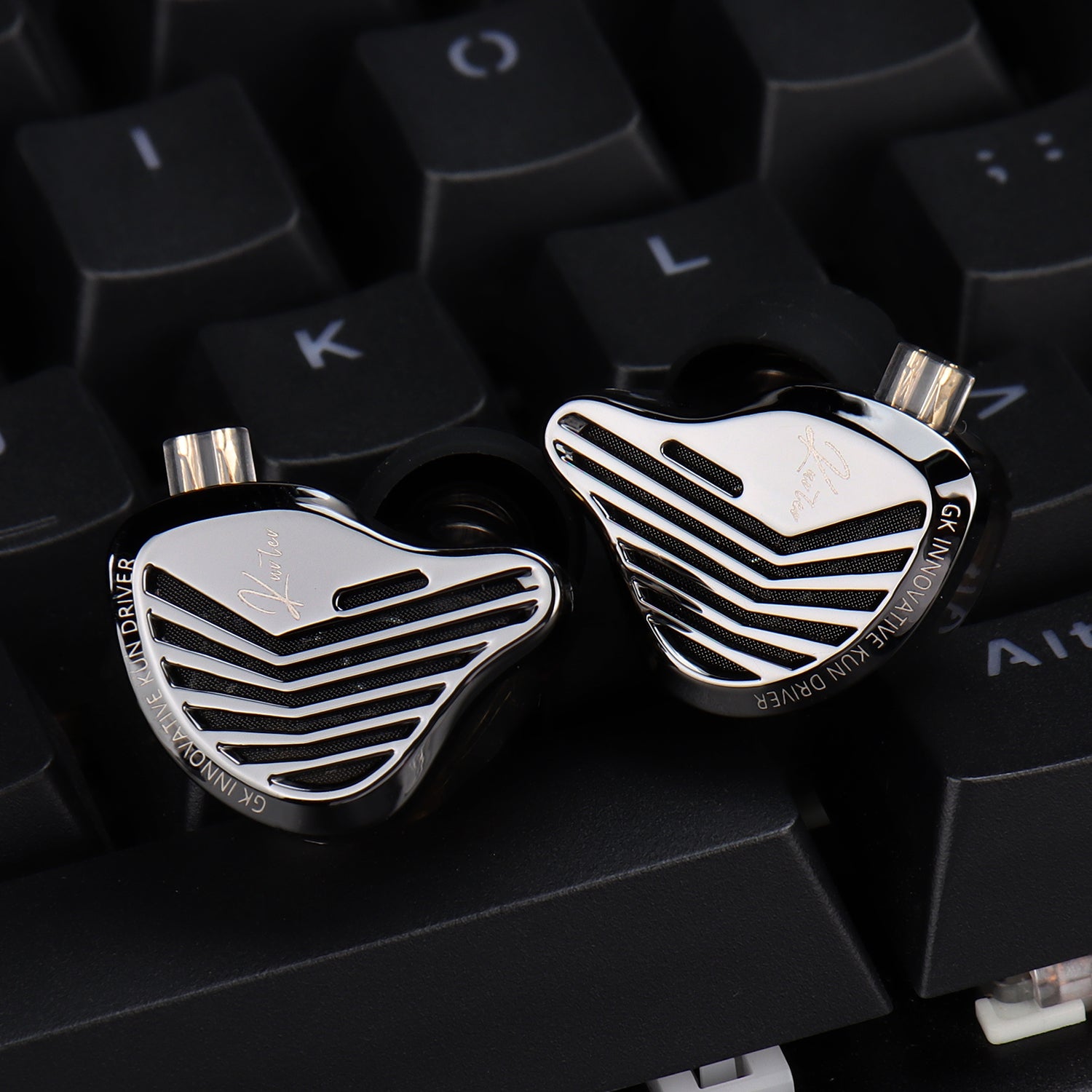 Close-up of high-end earbud components on a keyboard