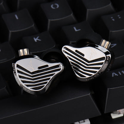 Close-up of high-end earbud components on a keyboard