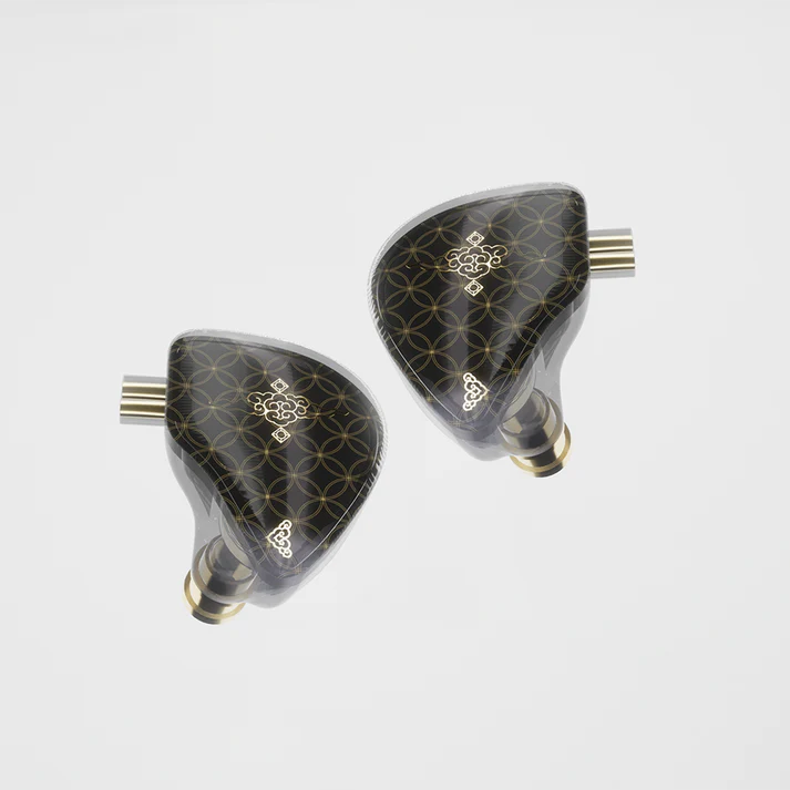 Pair of black and gold IEMs on a white background