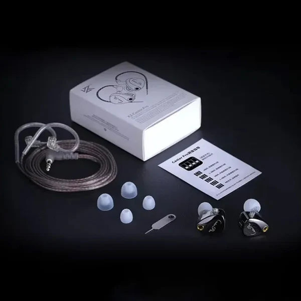 KZ Castor Pro with a clear transparent cable, four silicone ear tips, a small metal tool, and a white retail box on a black background.