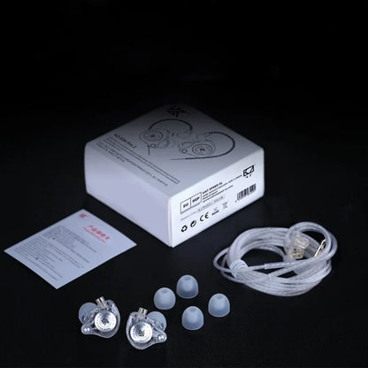 Set of KZ EDX Pro 2 including a box, earbuds, and cables on a black background