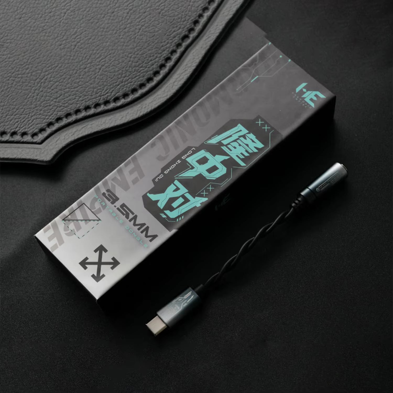 HE Longzhong box and cable on top of a dark fabric surface