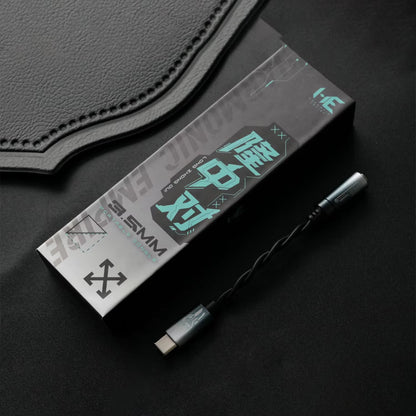 HE Longzhong box and cable on top of a dark fabric surface