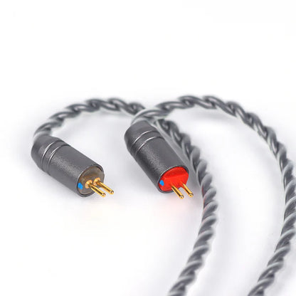 A close-up of a twisted gray audio cable with two connector ends, one showing gold pins with a small blue accent and the other with gold pins and a red accent, on a white background.