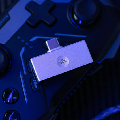 Allergo mini DAC resting on a dark blue gaming controller.