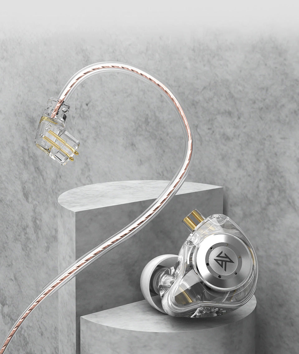 A transparent and silver KZ EDX Pro 2 earpiece with a braided cable, displayed on a gray concrete pedestal against a textured gray background.