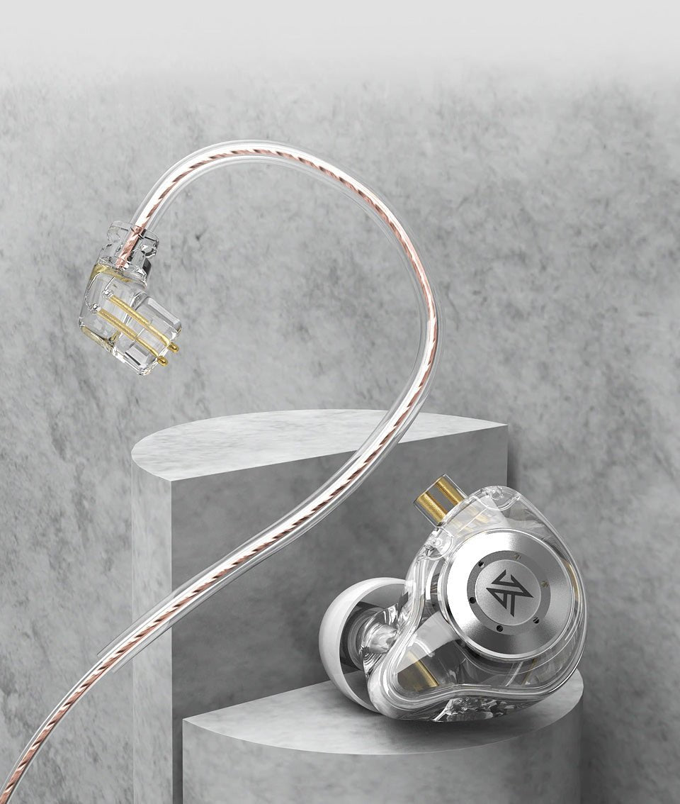 A transparent and silver KZ EDX Pro 2 earpiece with a braided cable, displayed on a gray concrete pedestal against a textured gray background.