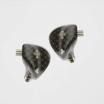 Pair of black and gold IEMs on a white background